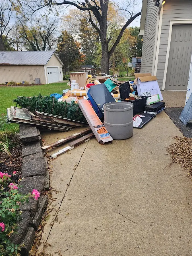 Dumpster being loaded with debris for Estate Cleanout Dumpster Rental in Eliot